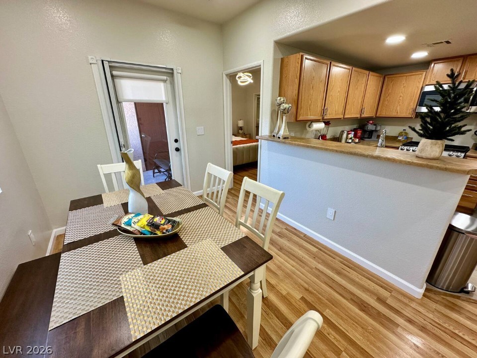 9580 West Reno Avenue, Unit 169 Las Vegas, NV 89148 - Photo 4 of 15 Hardwood floors and ample counter space define this inviting eat-in kitchen with an adjacent dining area.