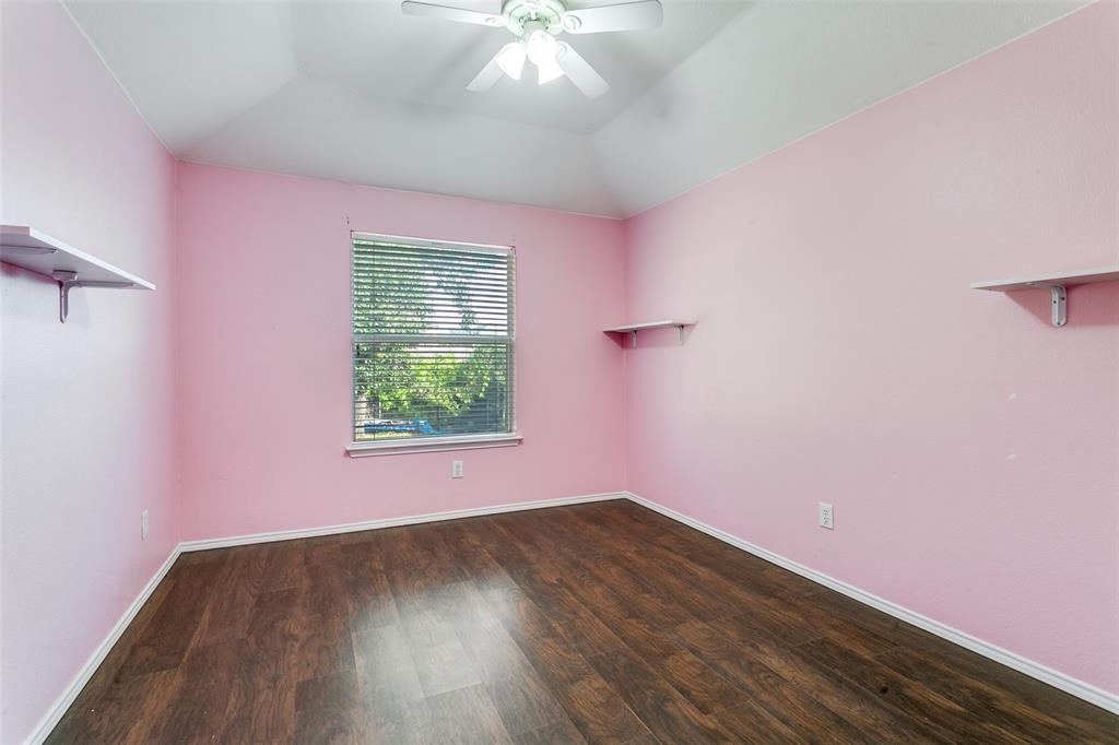 2408 Graystone Lane Corinth, TX 76210 - Photo 16 of 17 a view of a room with wooden floor and windows