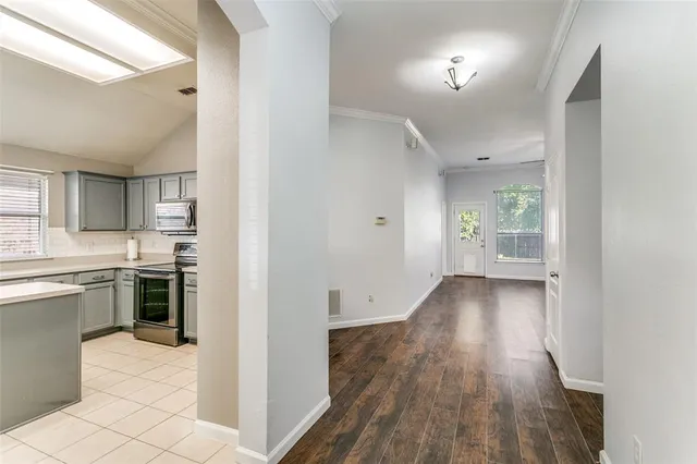 a view of a kitchen from the hallway with a window
