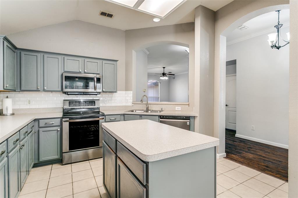 2408 Graystone Lane Corinth, TX 76210 - Photo 6 of 17 a kitchen that has a sink and a stove in it
