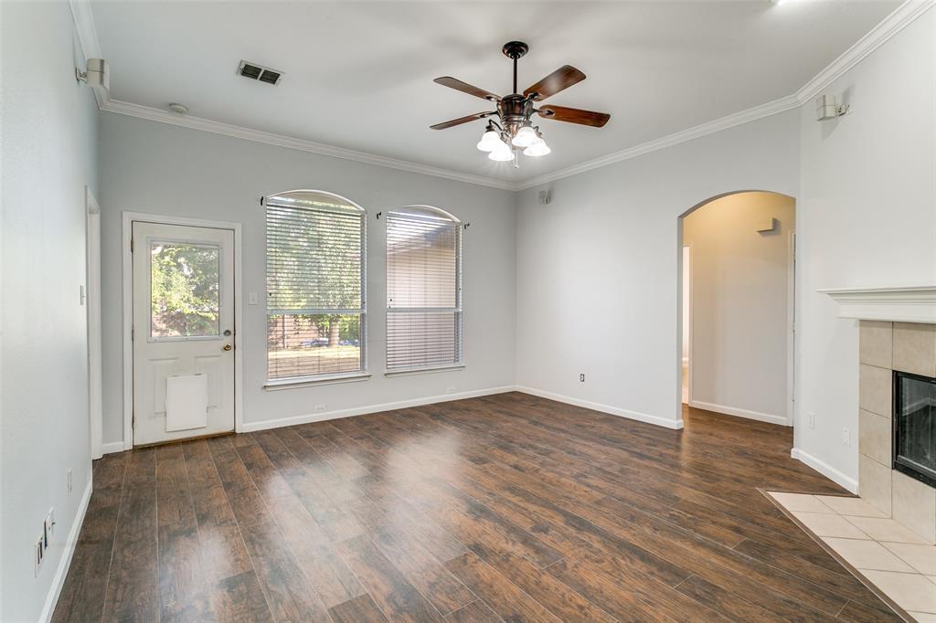 2408 Graystone Lane Corinth, TX 76210 - Photo 9 of 17 a view of an empty room with a window and wooden floor