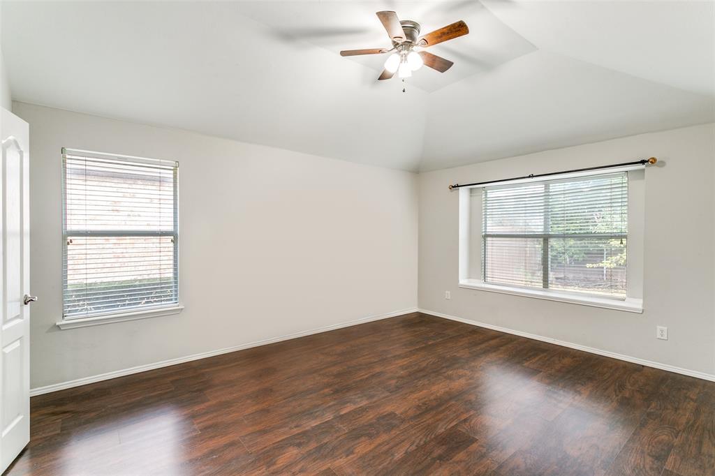 2408 Graystone Lane Corinth, TX 76210 - Photo 10 of 17 a view of an empty room with wooden floor and a window