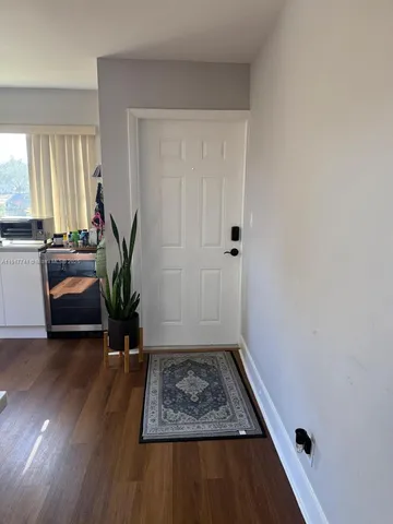 a view of an entryway with wooden floor