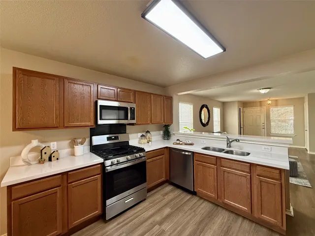 a kitchen with stainless steel appliances granite countertop a sink stove microwave and cabinets