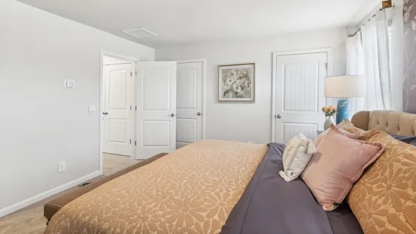 a bedroom with a bed and a lamp