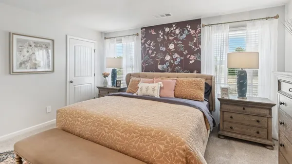 a bedroom with a large bed and a window