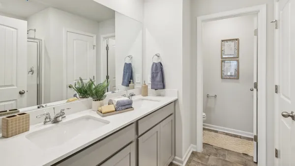 a bathroom with double vanity sinks a vanity and a mirror