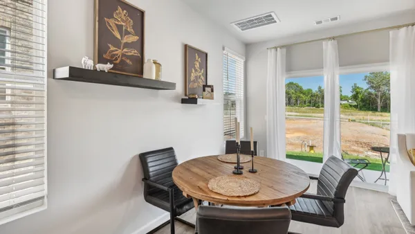 a dining room with furniture and window