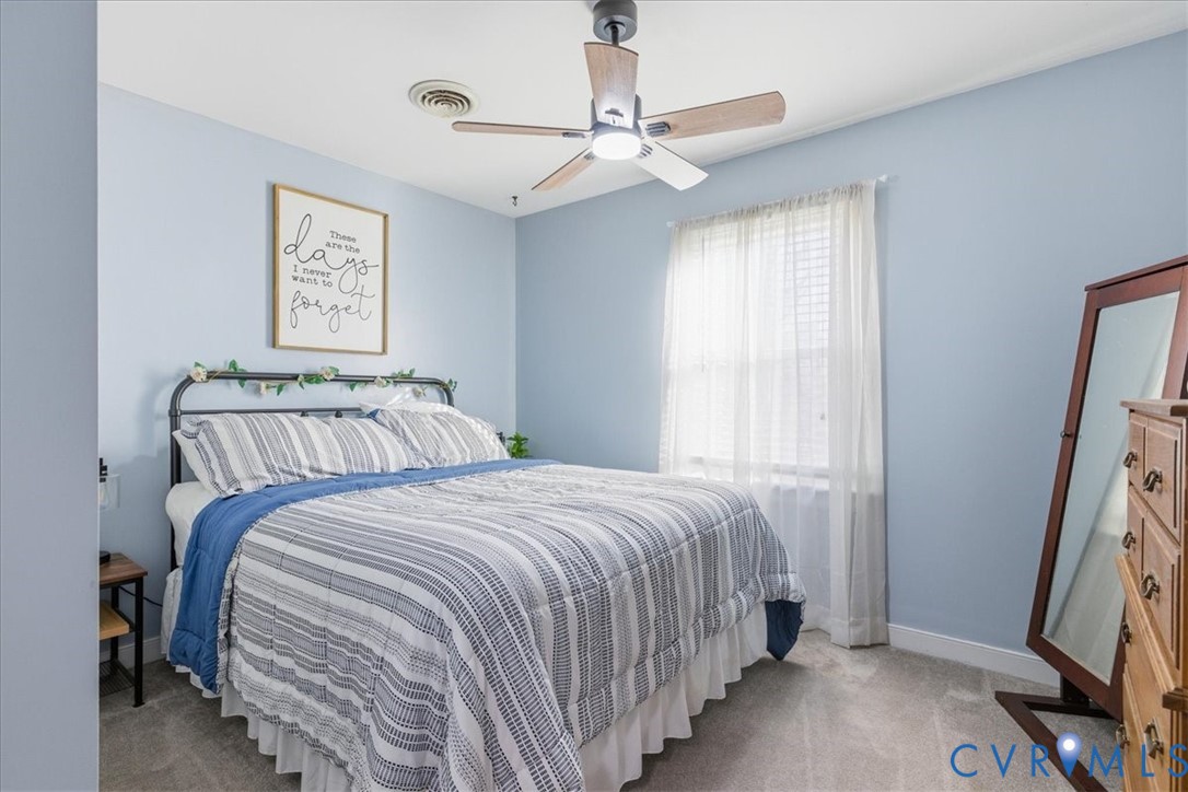 13504 Taylor Drive Disputanta, VA 23842 - Photo 12 of 49 a bedroom with a bed and a window