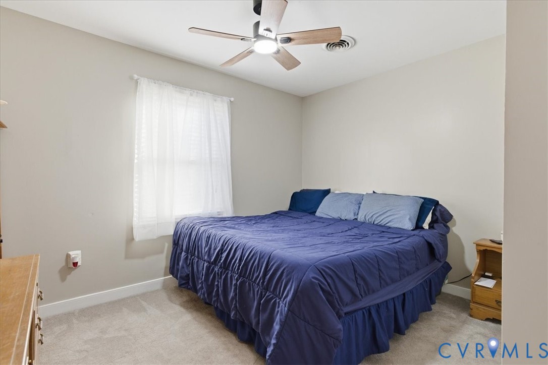 13504 Taylor Drive Disputanta, VA 23842 - Photo 14 of 49 a bedroom with a bed and window