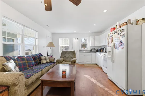 a kitchen with white cabinets and white appliances
