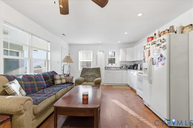 a kitchen with white cabinets and white appliances