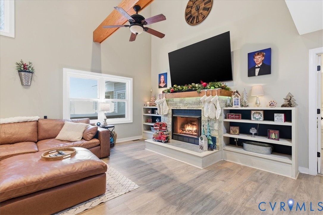 13504 Taylor Drive Disputanta, VA 23842 - Photo 35 of 49 a living room with furniture a flat screen tv and a fireplace