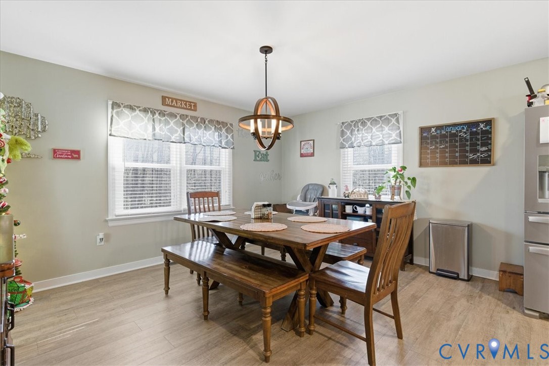 13504 Taylor Drive Disputanta, VA 23842 - Photo 39 of 49 a view of a dining room with furniture window and wooden floor