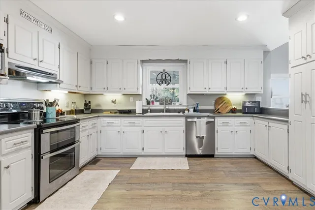 a view of kitchen with furniture and wooden floor