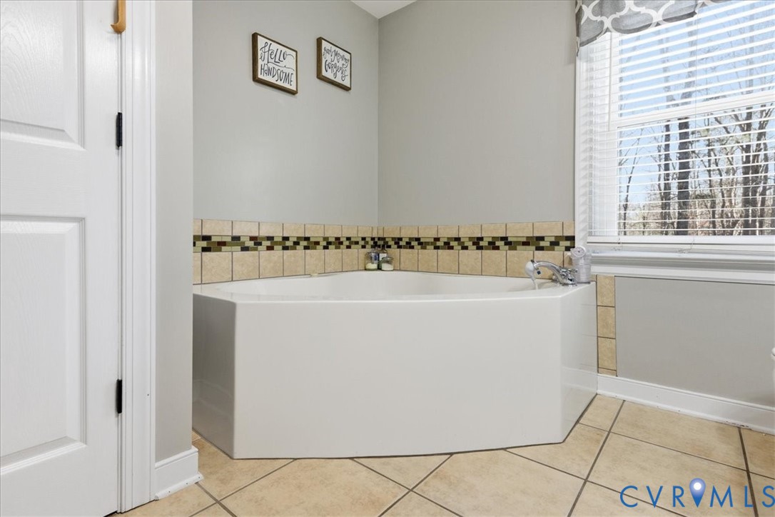 13504 Taylor Drive Disputanta, VA 23842 - Photo 42 of 49 a white bath tub sitting in a bathroom next to a window