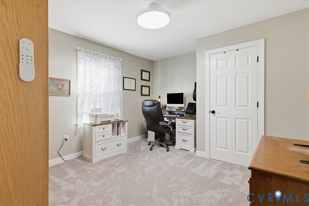 13504 Taylor Drive Disputanta, VA 23842 - Photo 10 of 49 a view of a bedroom with workspace and a window