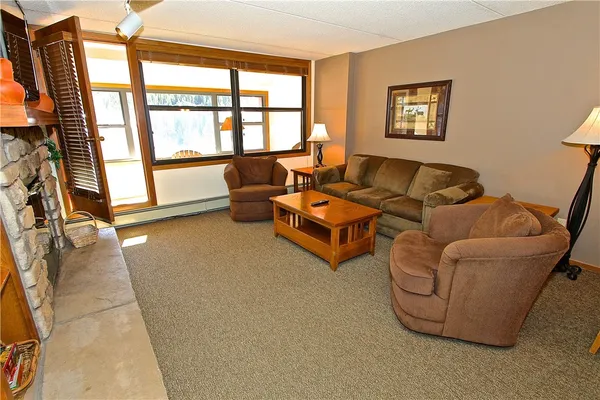 a living room with furniture and a floor to ceiling window