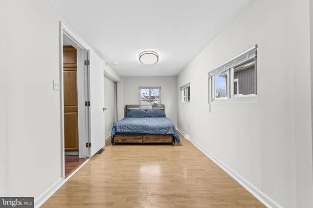 a bedroom with a bed and a large mirror