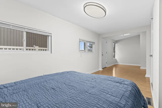 a view of a room with wooden floor and white walls