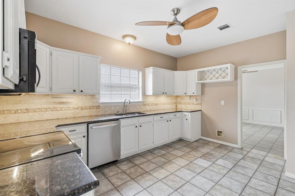 605 Andover Lane Coppell, TX 75019 - Photo 16 of 39 a kitchen with a sink cabinets and window