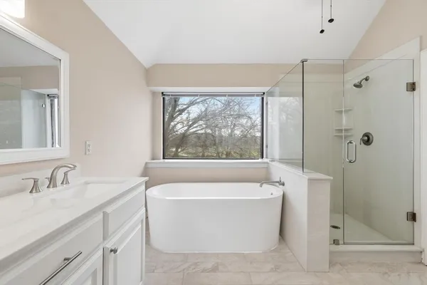 a white bath tub sitting next to a white sink
