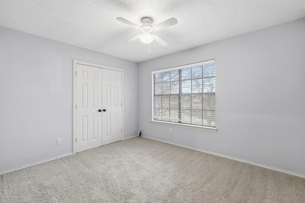 605 Andover Lane Coppell, TX 75019 - Photo 27 of 39 an empty room with windows and ceiling fan