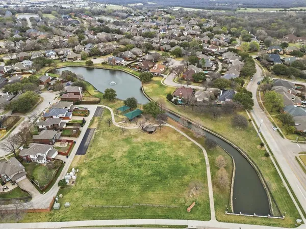 an aerial view of a residential houses with outdoor space and parking
