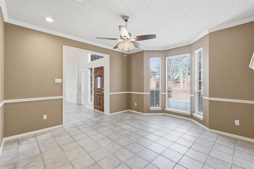 605 Andover Lane Coppell, TX 75019 - Photo 4 of 39 an empty room with chandelier fan and windows