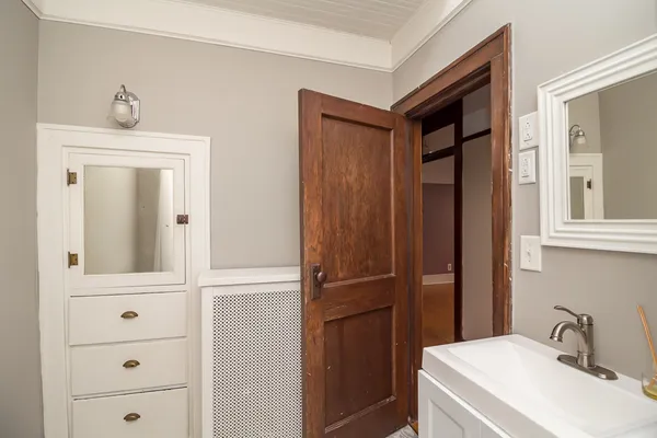 a bathroom with a sink a mirror and shower