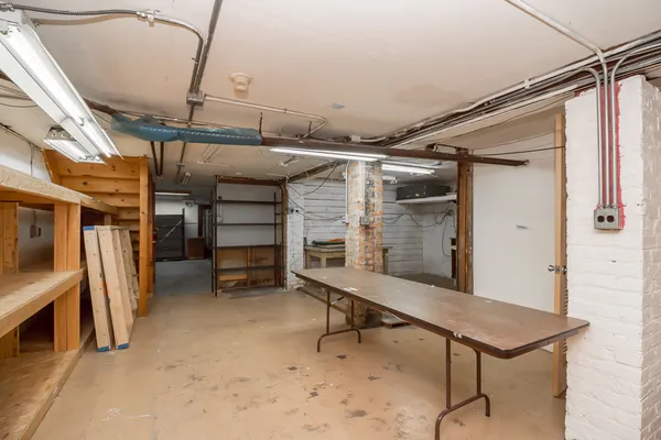 a room with storage and a car parked