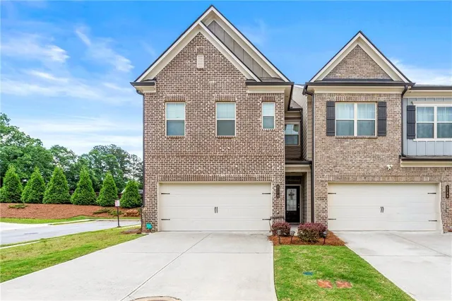 a front view of a house with a yard