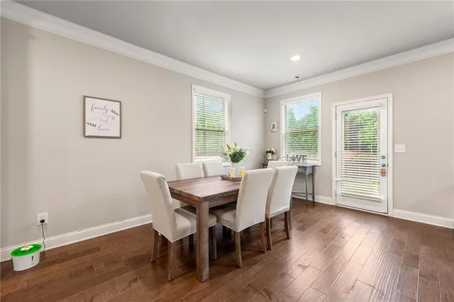 a view of a dining room with furniture window and wooden floor