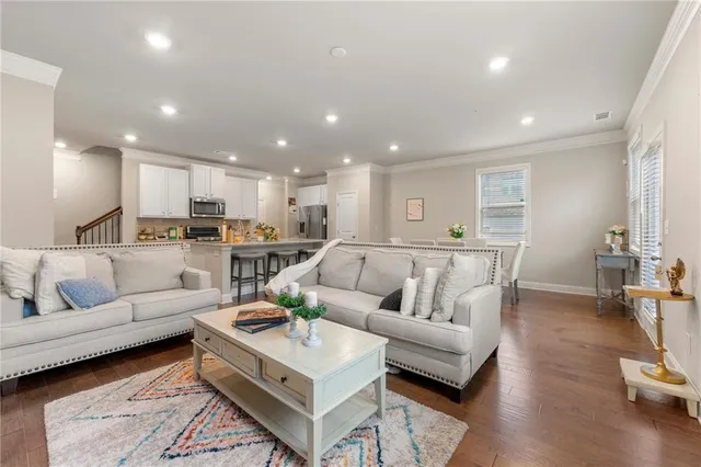 a living room with furniture and kitchen view