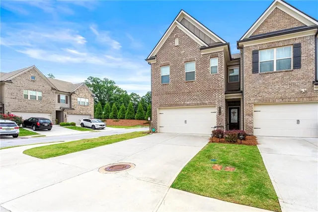 a front view of a house with a yard and garage