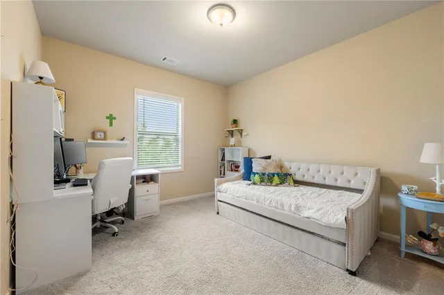 a bedroom with a bed and a desk