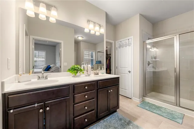 a view of a bathroom with tub mirror and window