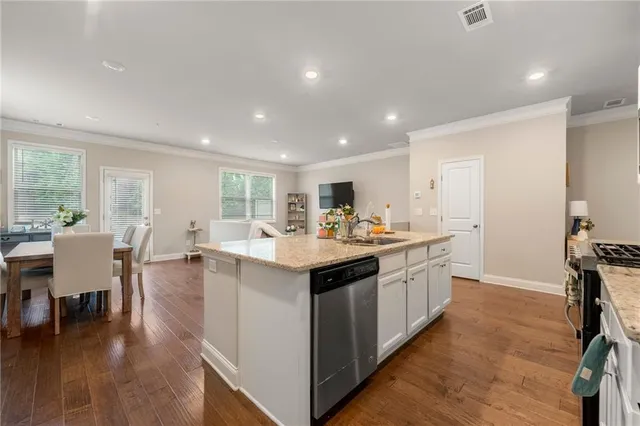 a kitchen with center island cabinets and wooden floor