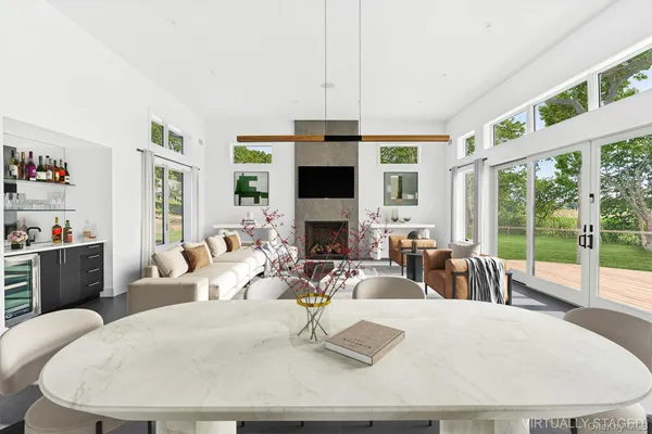 a living room with fireplace furniture large window and a fireplace