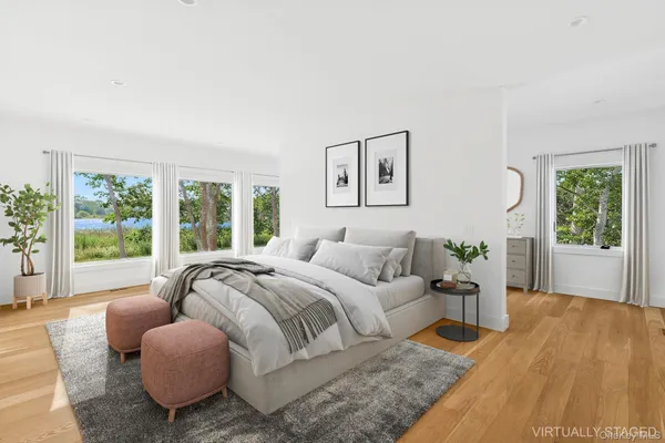 a bedroom with a bed and glass window