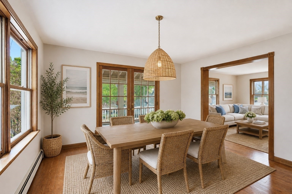67 Wituwamat Road Weymouth, MA 02191 - Photo 6 of 42 a view of a dining room and livingroom with furniture wooden floor a chandelier