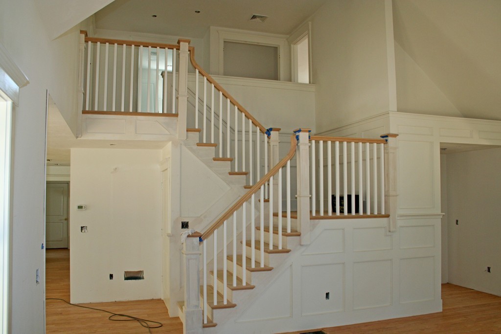 90 Pine Ridge Road Brewster, MA 02631 - Photo 7 of 11 a view of staircase with lots of frames on wall and wooden floor