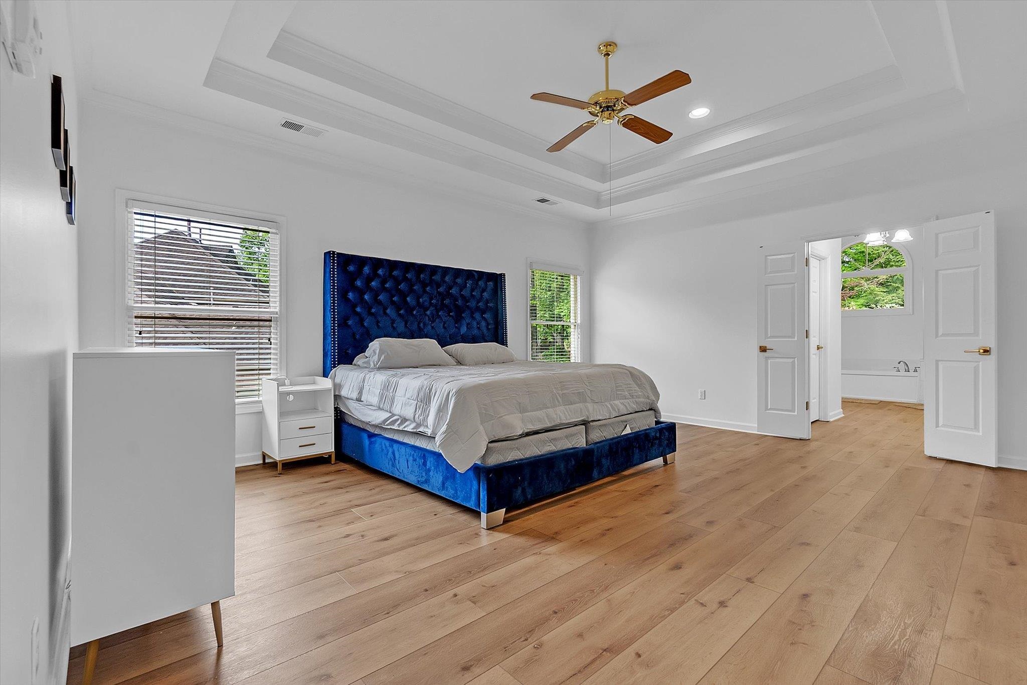 8786 Stablemill Lane Memphis, TN 38016 - Photo 11 of 40 a bedroom with a bed and a ceiling fan