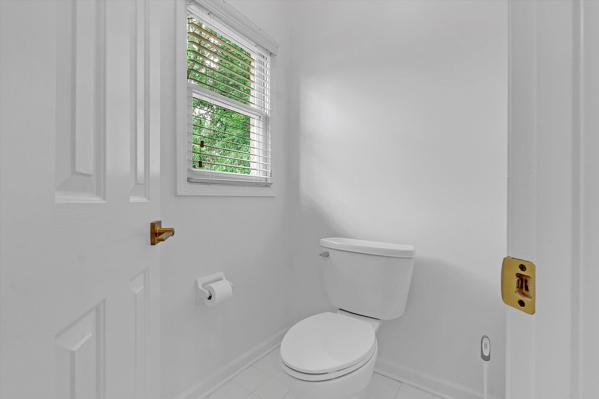 8786 Stablemill Lane Memphis, TN 38016 - Photo 14 of 40 a white toilet sitting next to a window