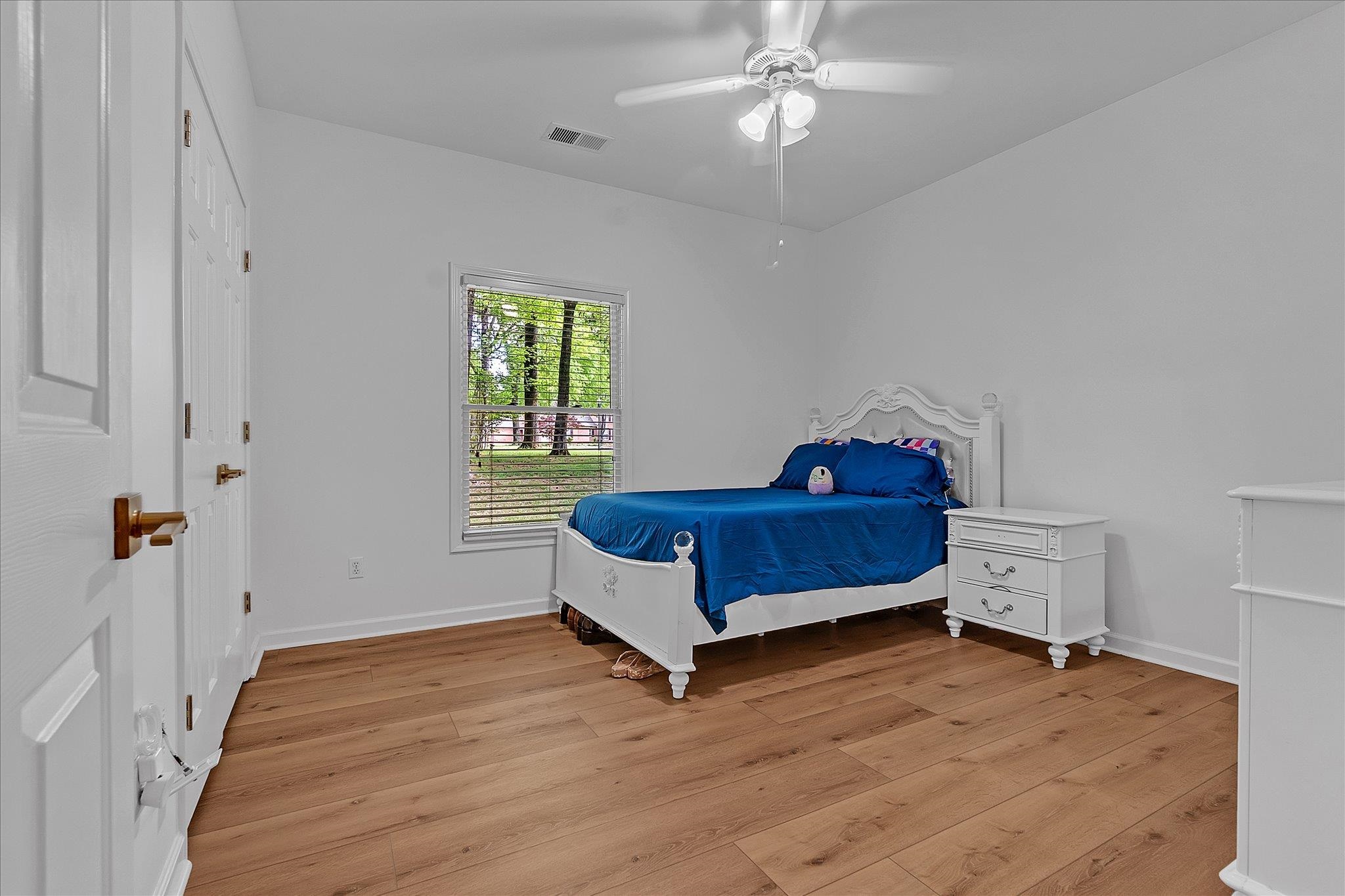 8786 Stablemill Lane Memphis, TN 38016 - Photo 32 of 40 a spacious bedroom with a bed and window