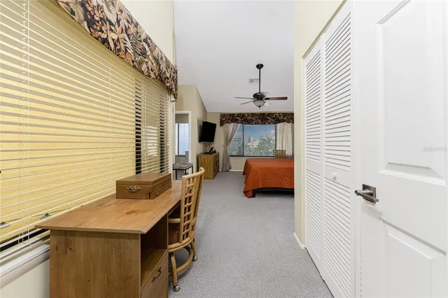 a bedroom with a bed a window and dresser