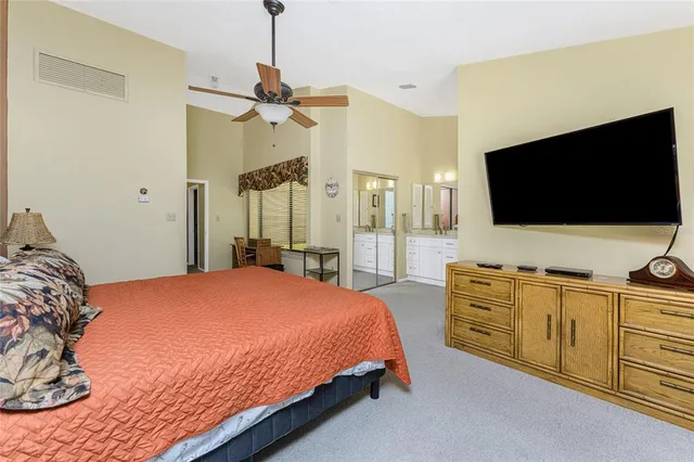 a spacious bathroom with a double vanity sink and mirror