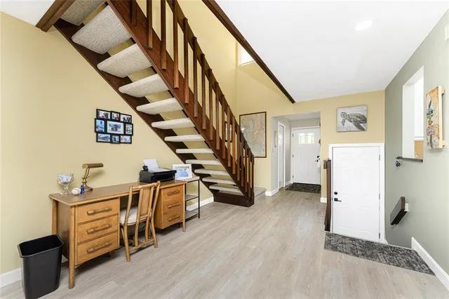 a view of a livingroom with furniture and stairs