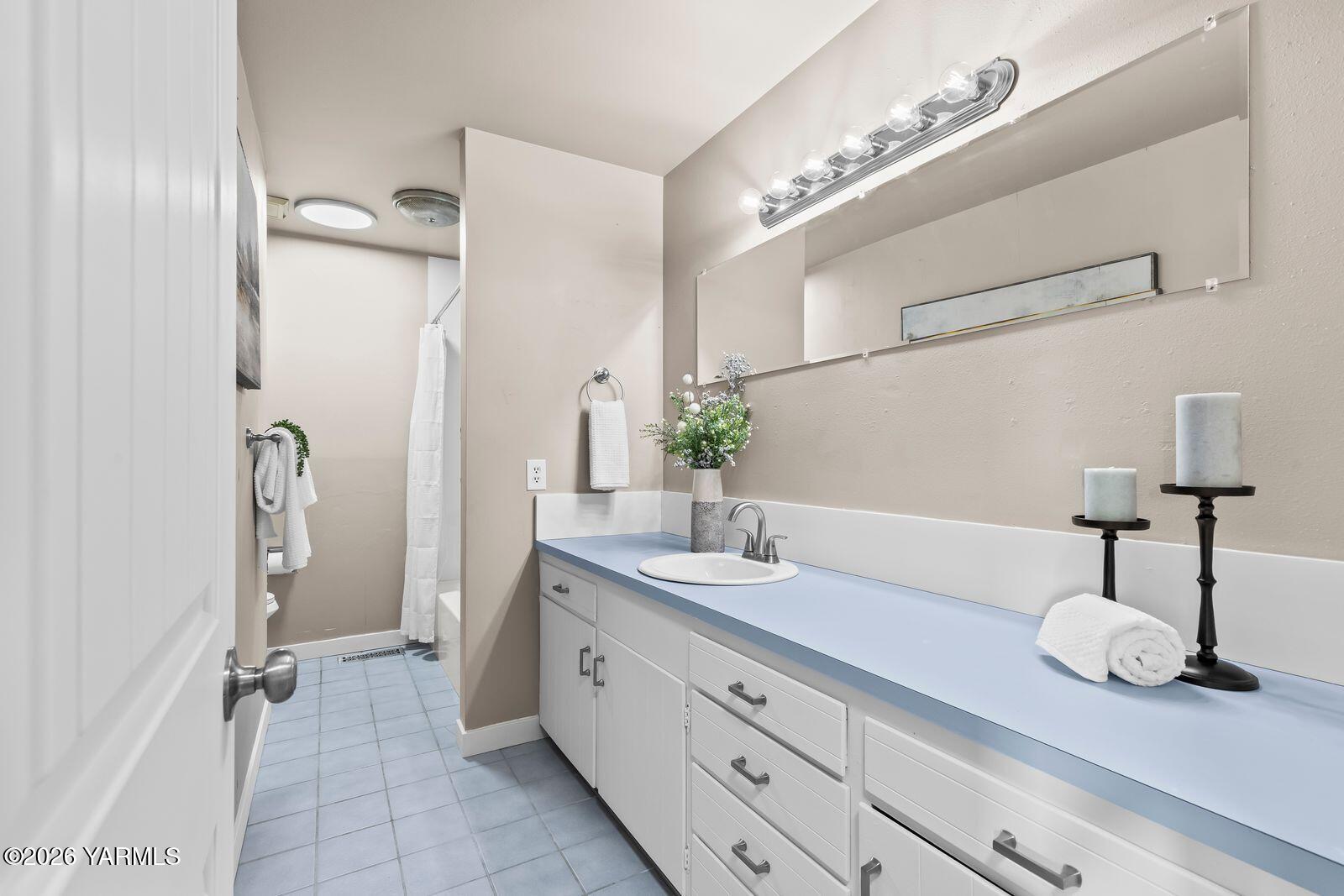 2030 Sunset Way Cowiche, WA 98923 - Photo 24 of 57 a spacious bathroom with a granite countertop sink a mirror and a shower