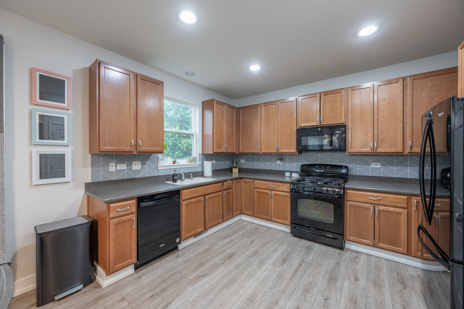 4333 Schofield Drive Oswego, IL 60543 - Photo 3 of 14 a kitchen with stainless steel appliances granite countertop a stove top oven a sink dishwasher a refrigerator and a microwave oven on the wooden floor